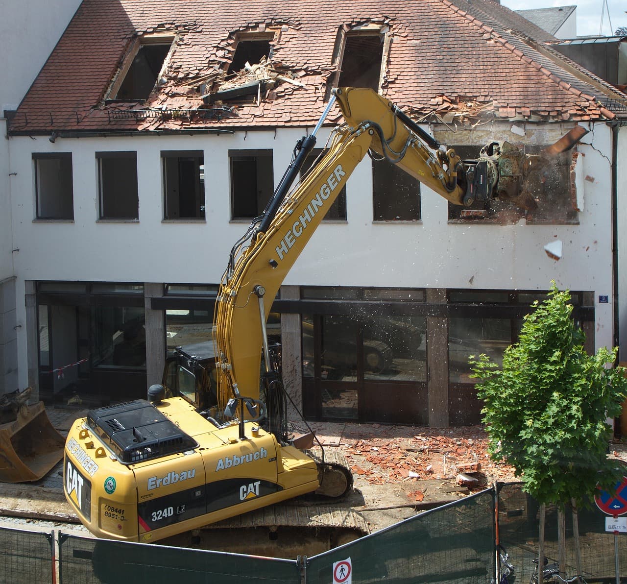 Excavators breaking down a house